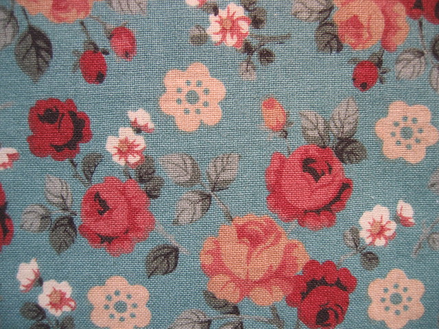 Close up of rose patterned blue fabric thrift shop find of kids stuff (Photo copyright H. Andersson)