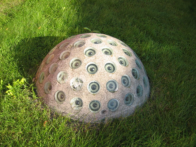 Outdoor sculpture with eyes Thing in the ground