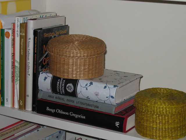 Round boxes and books in the bookshelf