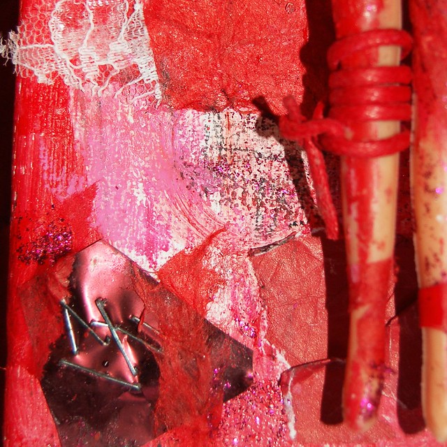 Detail of a red and glittery assemblage with playdoll on canvas Adulthood I by iHanna (Copyright Hanna Andersson) 2006