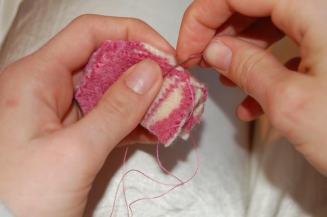 Sewing together a piece of a felted wool sweater to become a teddy bear (Photo copyright Hanna Andersson) 2006