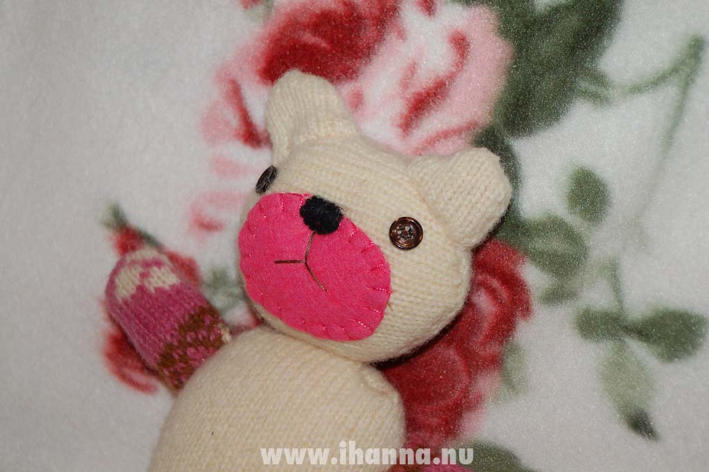 Wool felted sweater made into a teddy bear with button eyes face close up (Copyright Hanna Andersson)