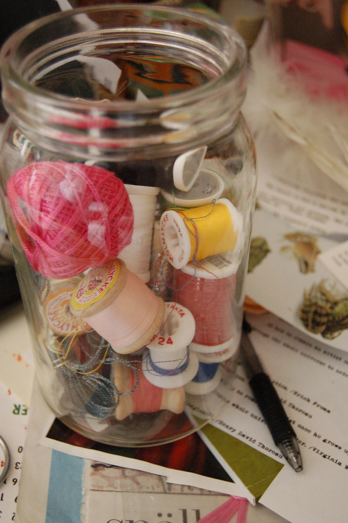 Glas jar of embroidery floss and spools of thread on my desk (Photo copyright Hanna Andersson) 2006