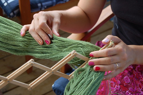 My colourful nails making new skeins of the green wool yarn on a yarn winder (Photo copyright Hanna Andersson)