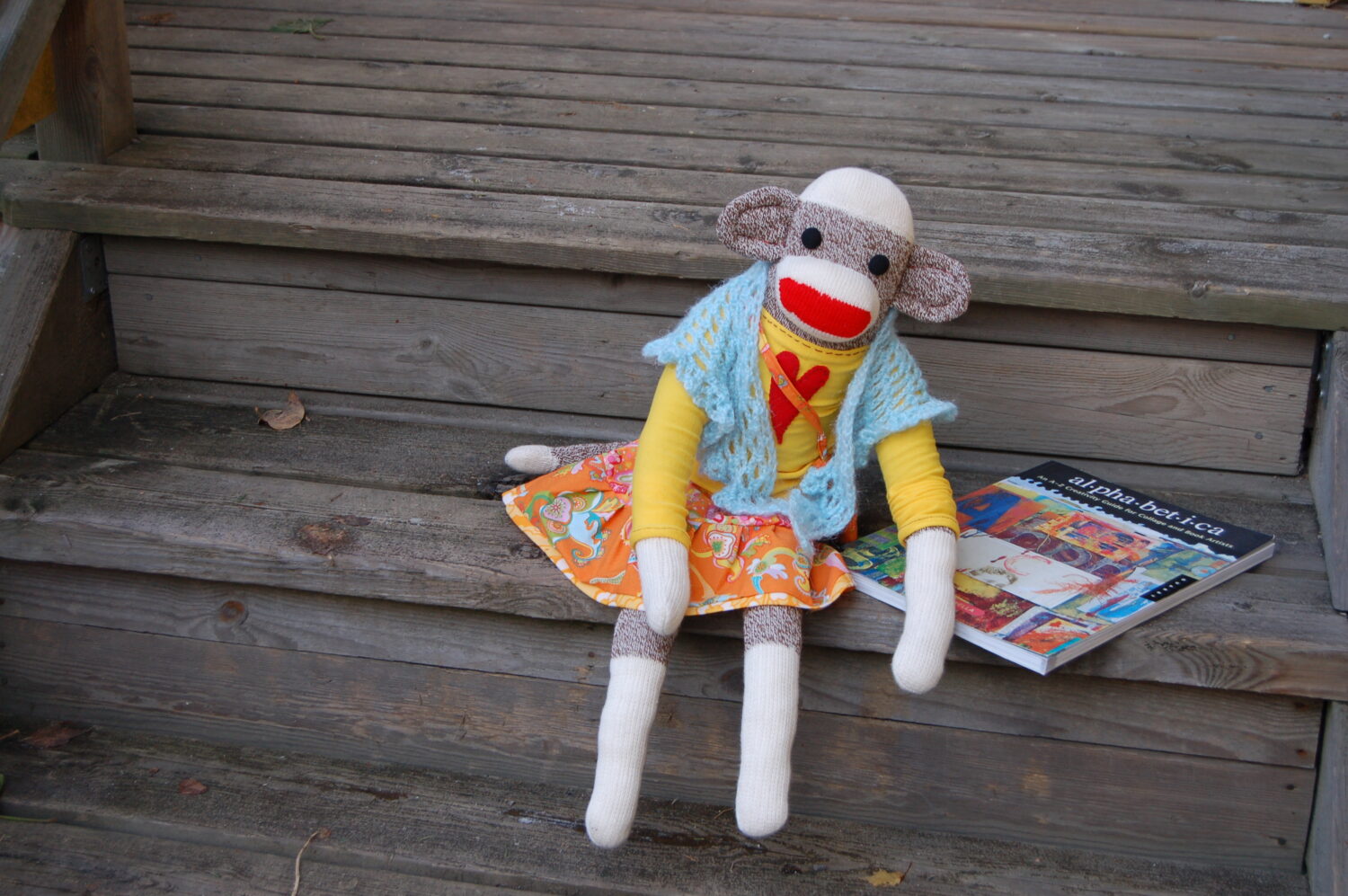 Finished huge sock monkey on the stairs in new clothes also by iHanna (Photo copyright Hanna Andersson)