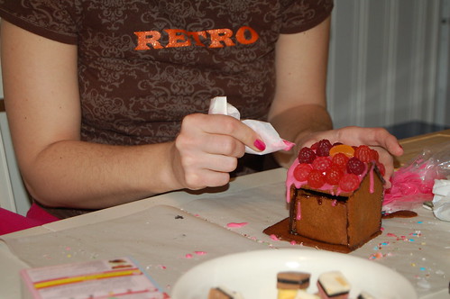 Me doing pink decorations on my gingerbread happy house