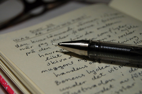 Ink pen on open notebook where the writing poetry daily is easy (Photo copyright Hanna Andersson)
