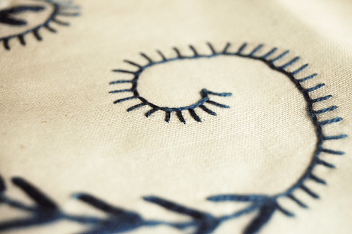 Embroidered swirl (Photo by iHanna - Hanna Andersson) Embroidered swirl on a table cloth at moms house in my soft and faded photography by iHanna (Copyright Photo Hanna Andersson)