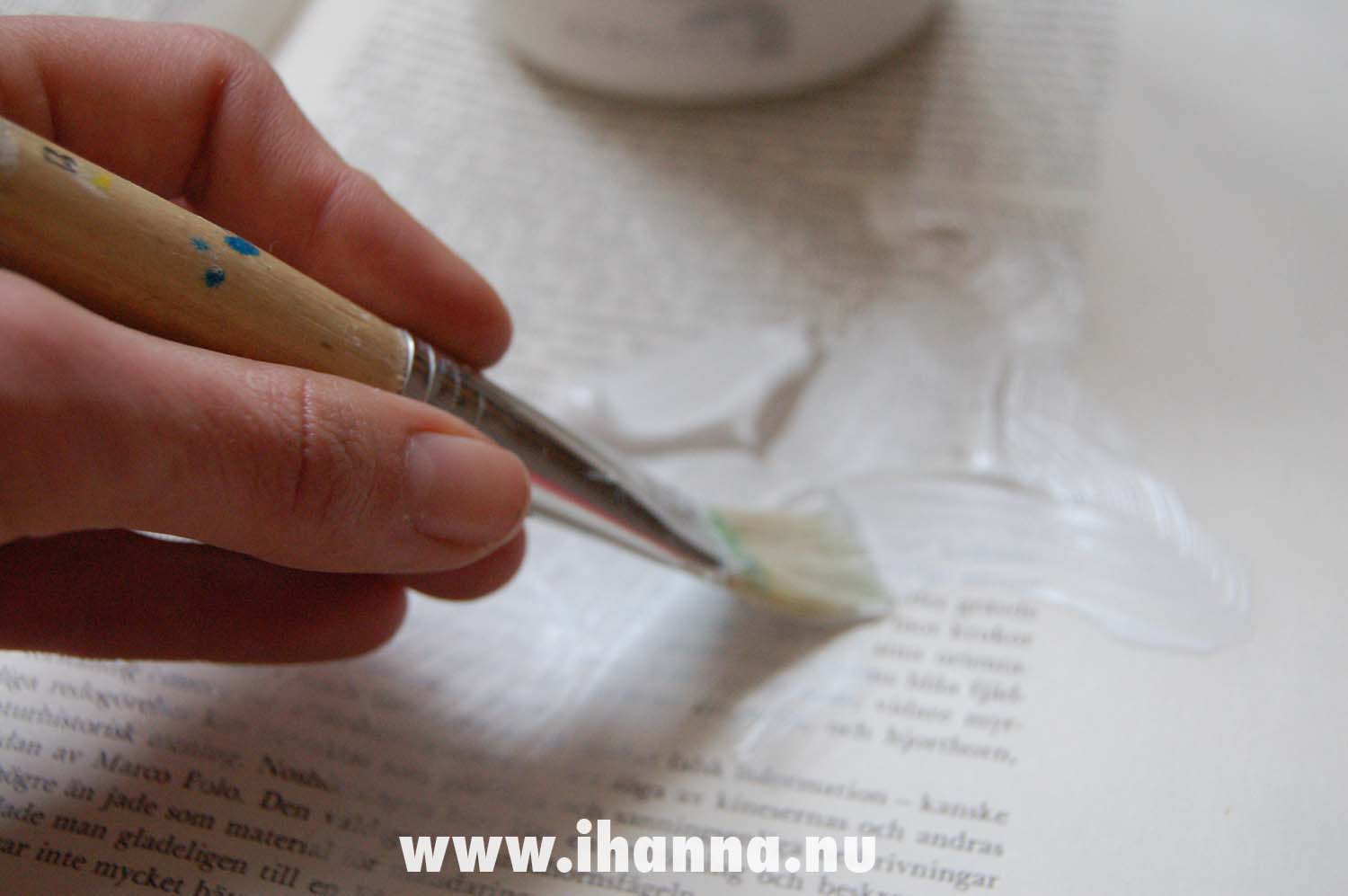 Painting or smearing gesso on the pages of this altered book (Photo and tutorial copyright Hanna Andersson)