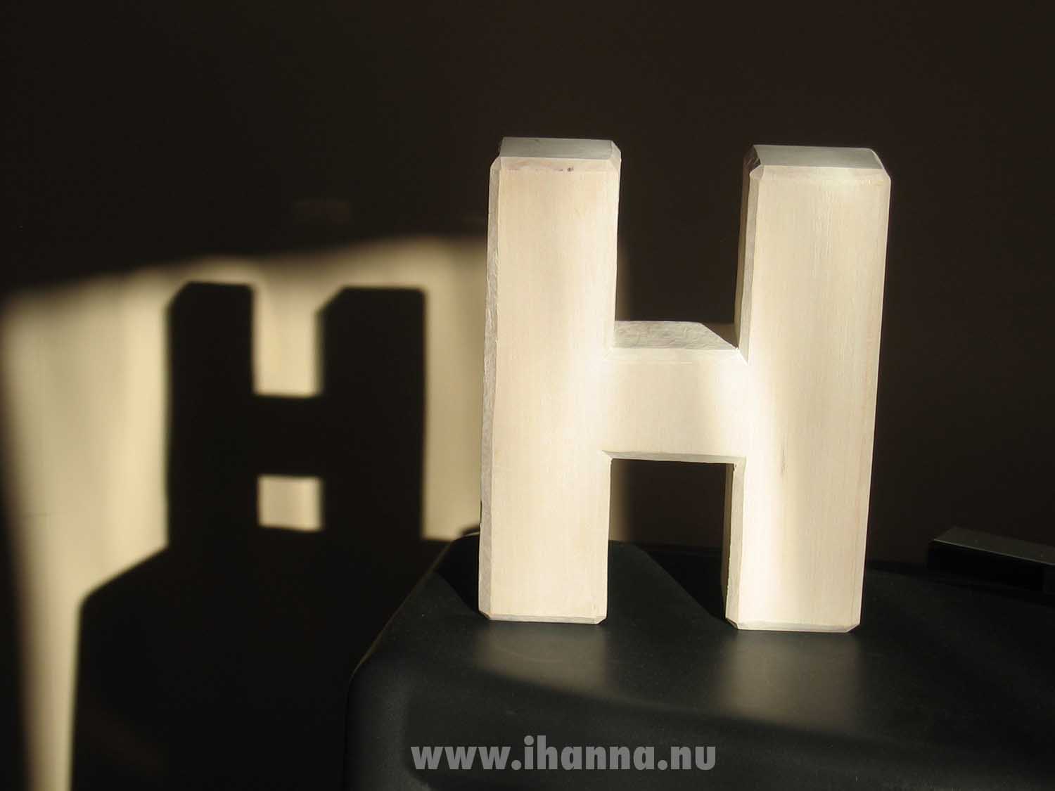 Woodwork H letter in the sun making a H shadow on the wall (Photo copyright Hanna Andersson)