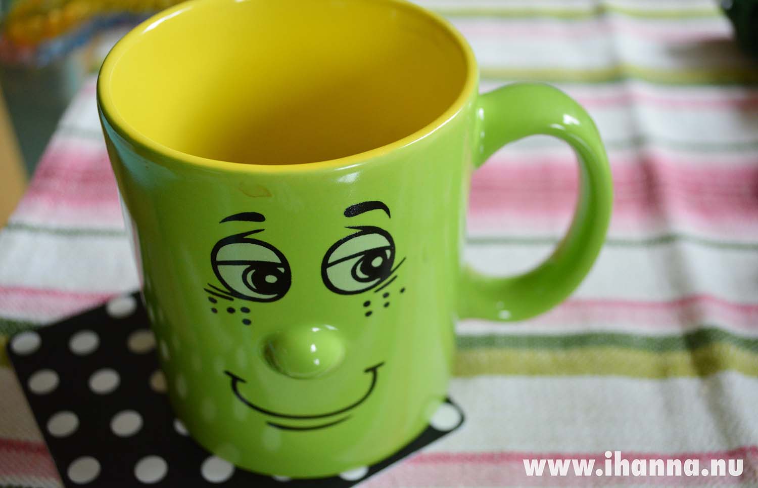 Green Smiling Coffee Cup mug on the table (Photo copyright H. Andersson)
