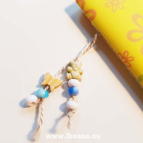 Bead dangle decoration on the yellow doodle book with blank pages | journal 26 in iHanna's Journal release 3 2021