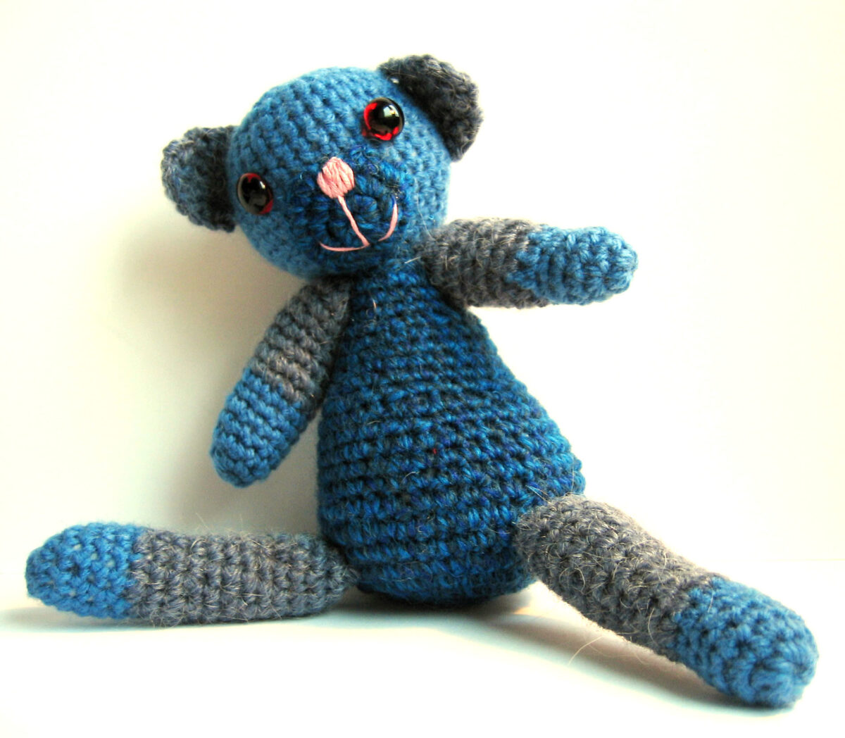 A blue hand crocheted softie made by Hanna Andersson