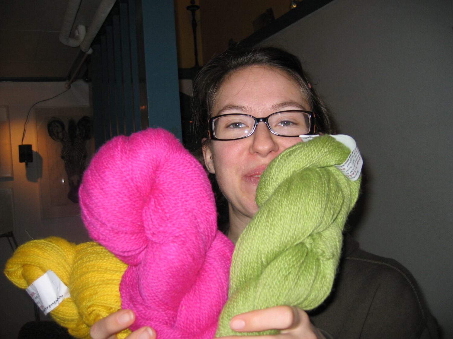Me petting and sniffing my new wool skeins (Photo by my brother)