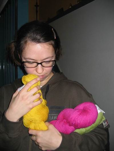 Me petting and sniffing my new wool skeins (Photo by my brother)