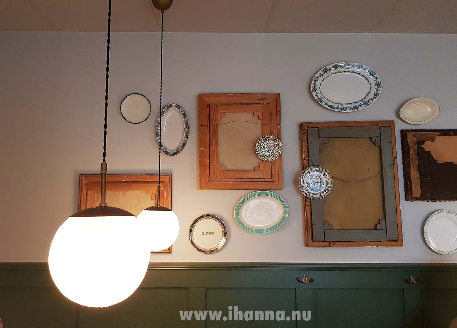 Vintage frames hung on the wall with the backside of the frame out together with oval plates.