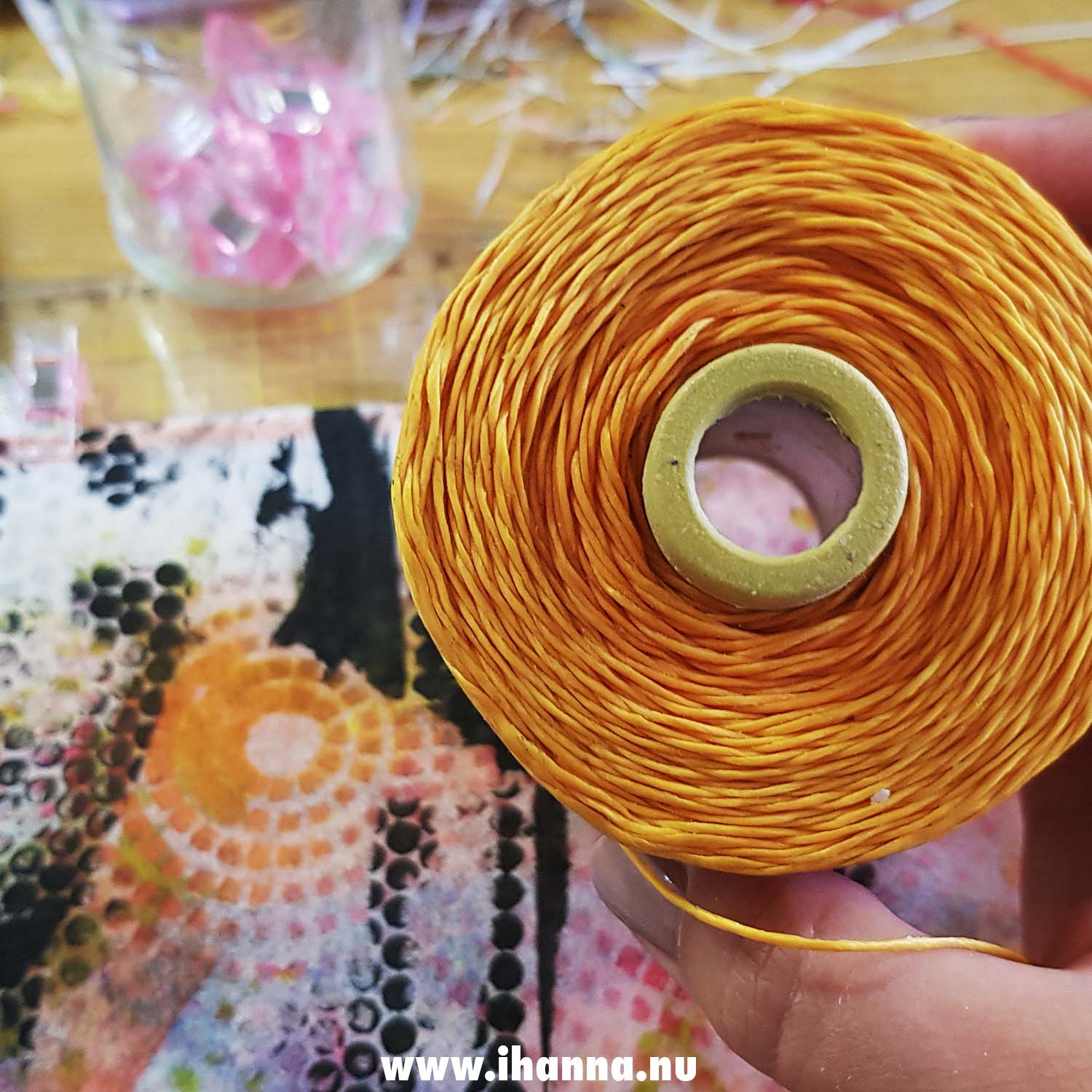 Spotted photo theme circle showing big spools of yellow waxed book binder's thread (Photo copyright H. Andersson) 2021