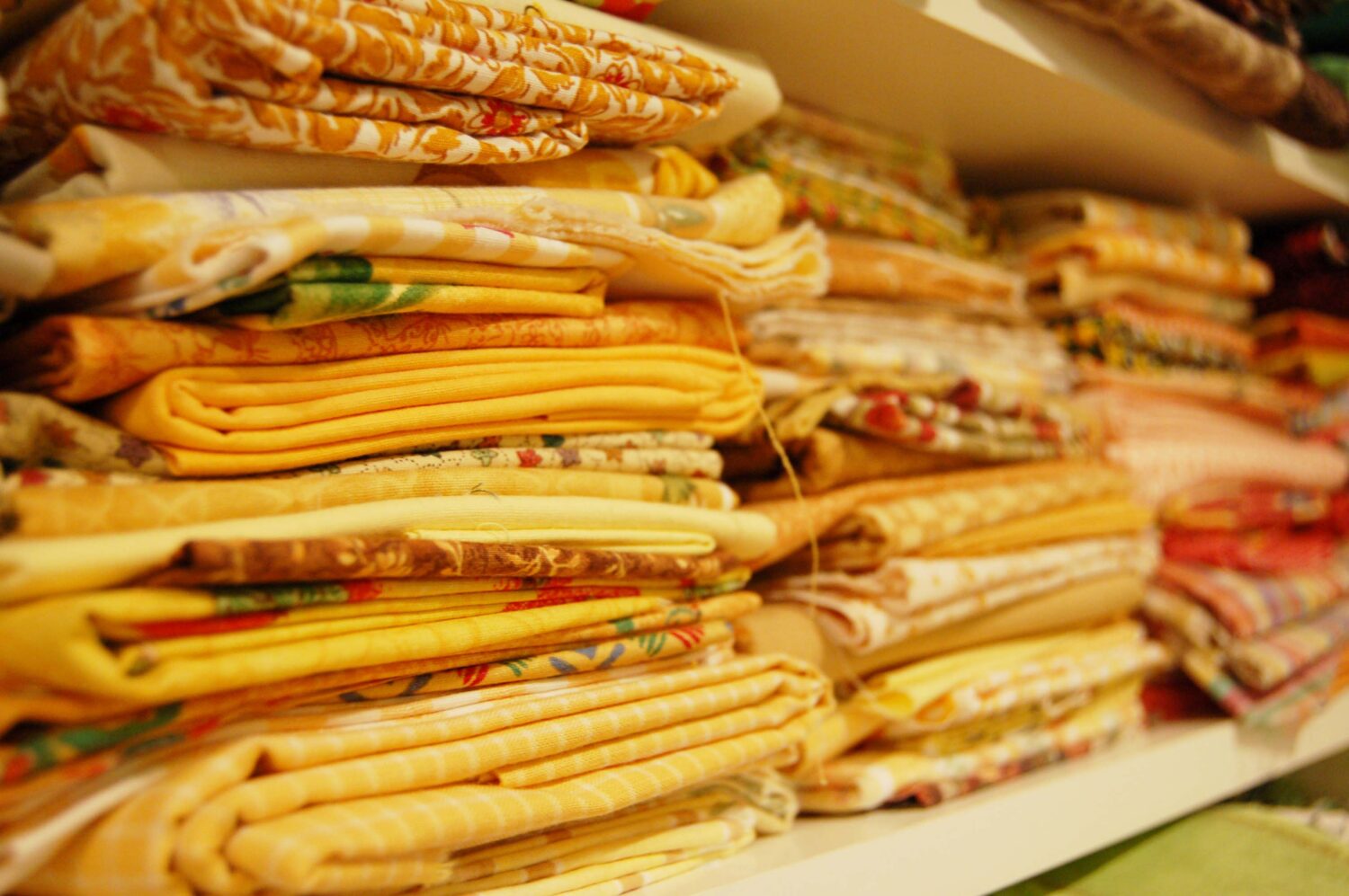 Moms stack her quilting fabric by color here yellow (Photo copyright Hanna Andersson)