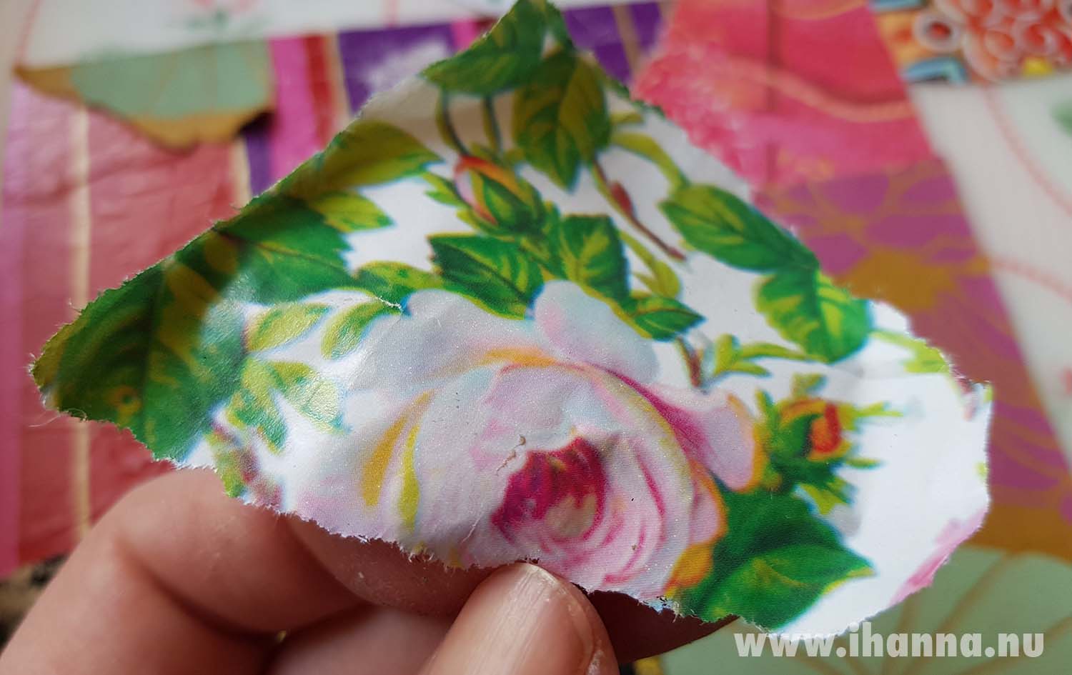 Paper scrap used wrapping paper with a pink rose pattern ready to be part of the anatomy of a collage (Copyright H. Andersson)